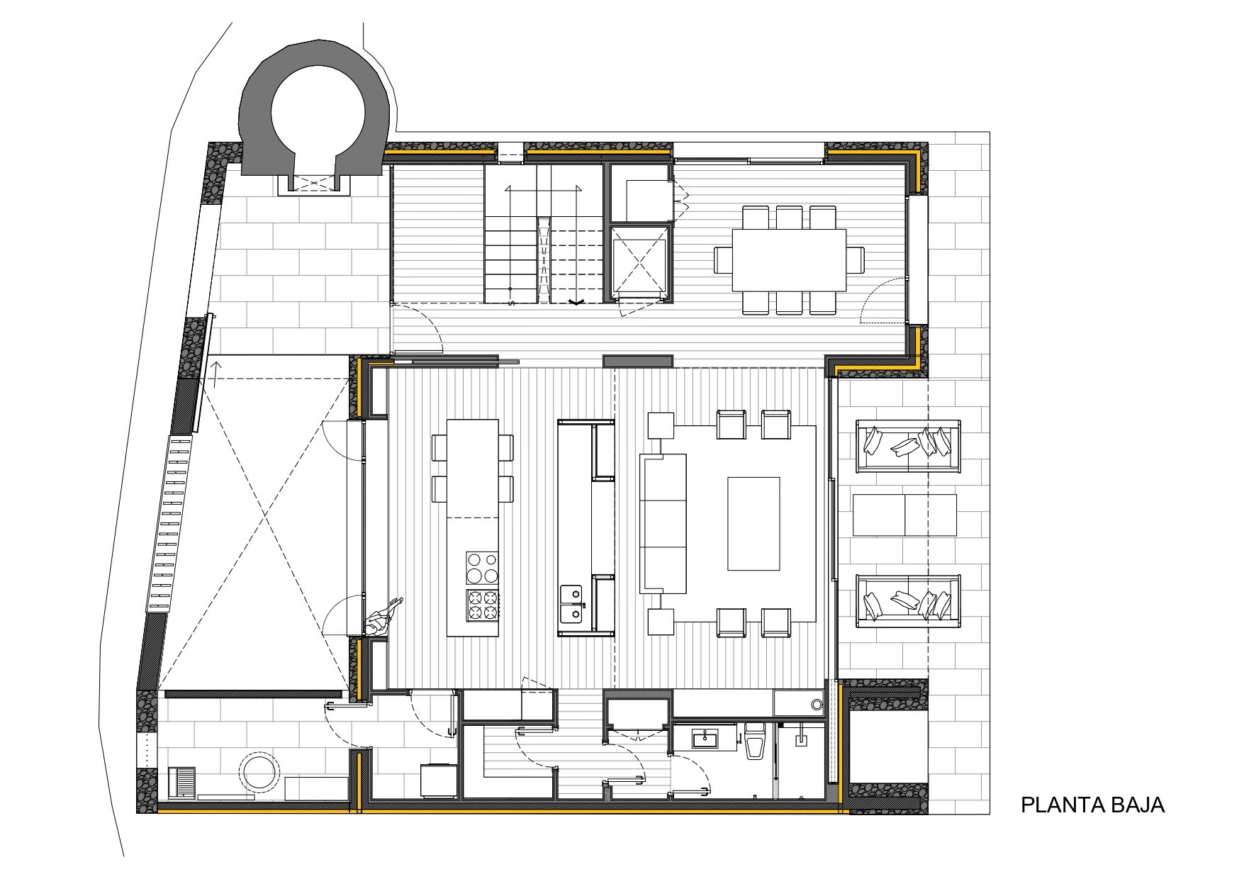 Plano arquitectónico denominado "Planta Baja" que muestra una distribución en planta baja con cocina, comedor, sala de estar, dos zonas de estar, escaleras, cuarto de baño y un elemento circular exterior en la parte superior izquierda.